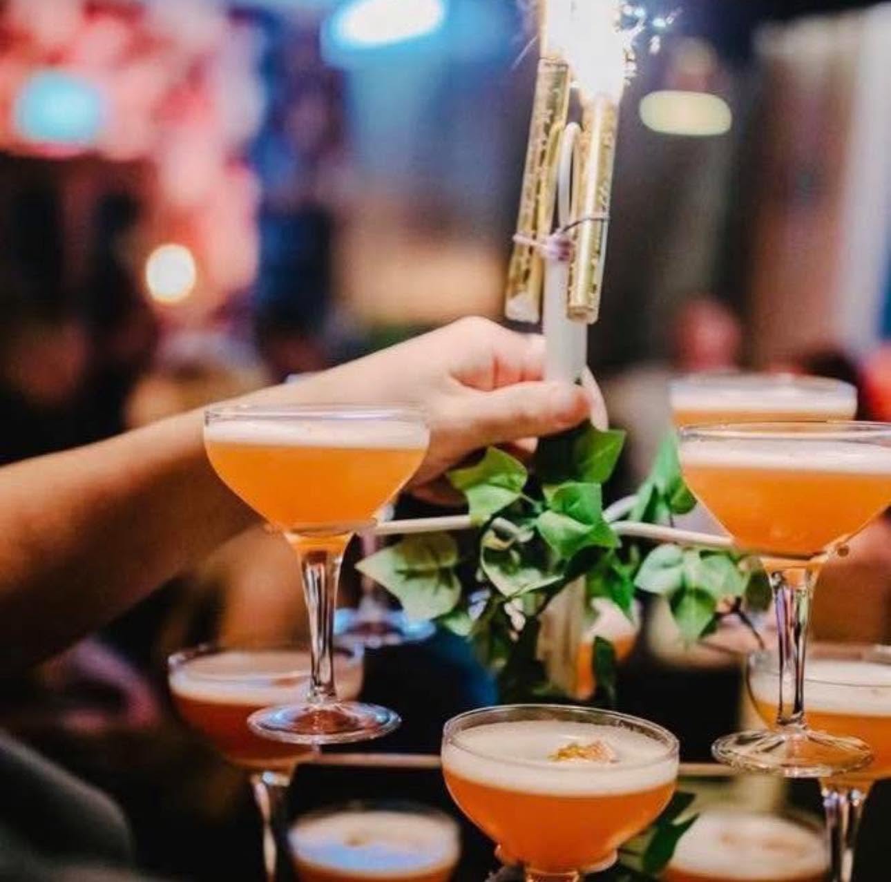 Cocktails garnished and passed over the bar
