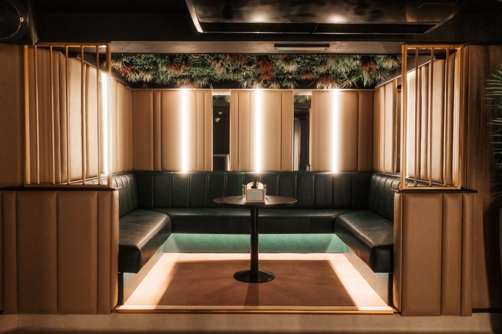 A private booth framed in gold rails and foliage