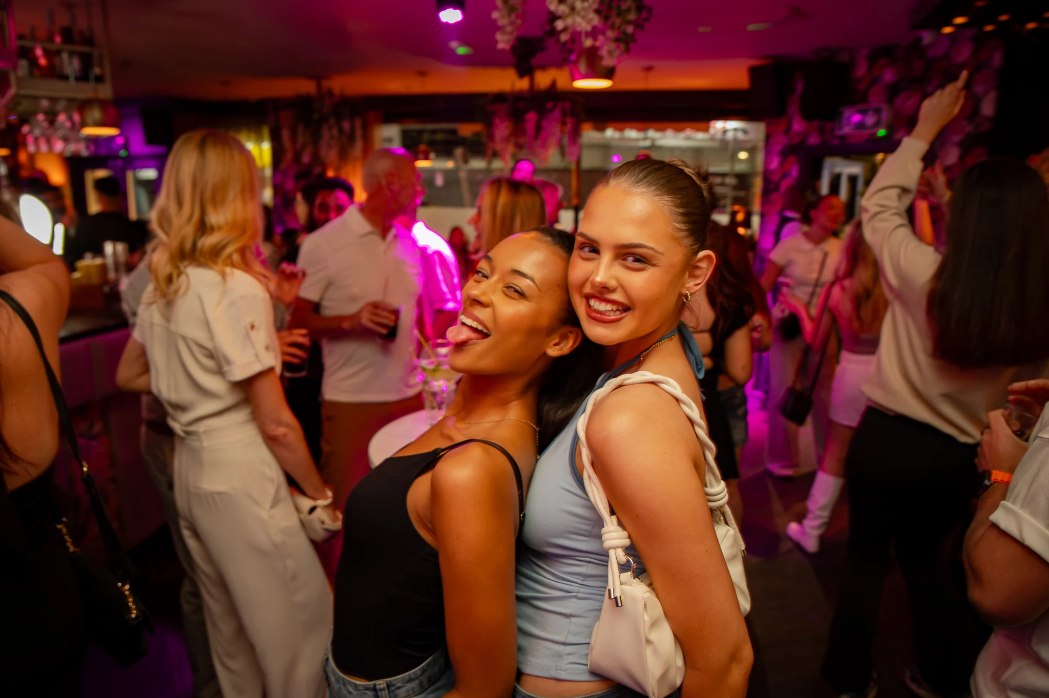The bar in full swing under pink light