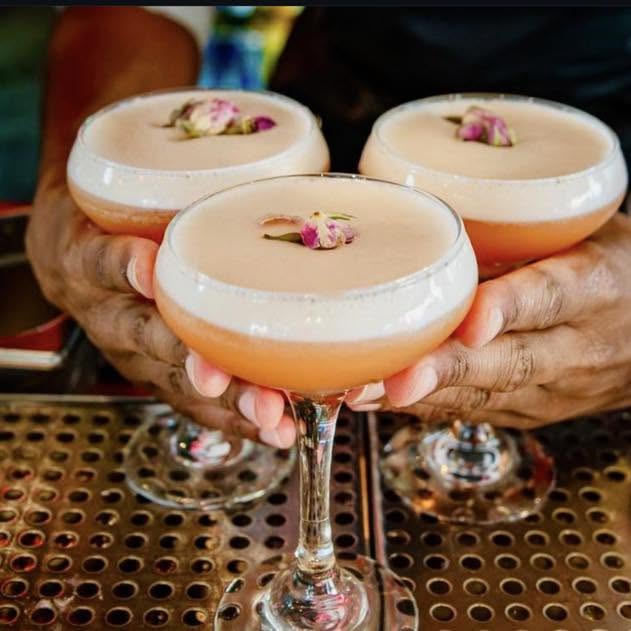 Three pornstar martinis held up for a toast