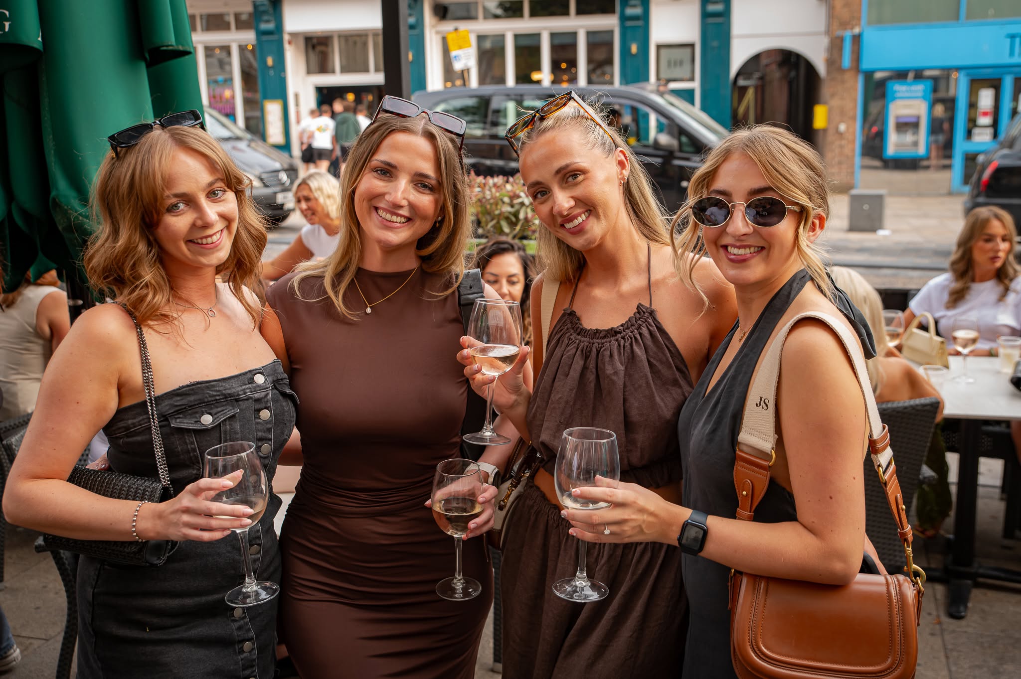 A group with drinks outside the bar on Church Street
