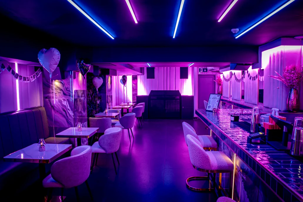 The VIP Room dressed for a party beneath blue neon, with its own bar