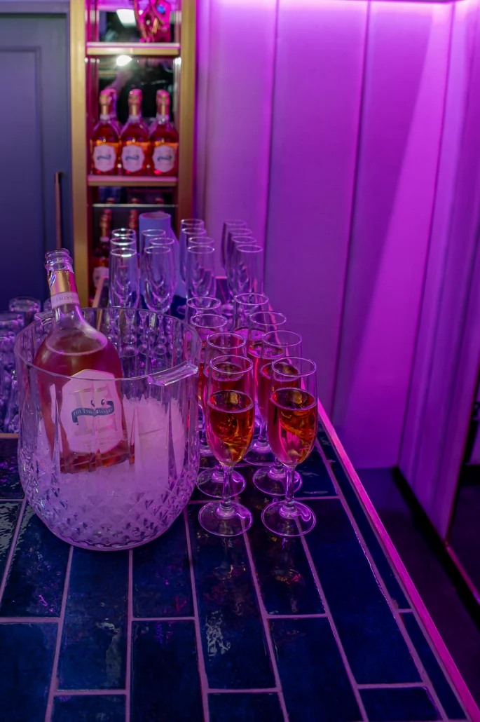 Champagne flutes poured on the VIP Room's tiled bar