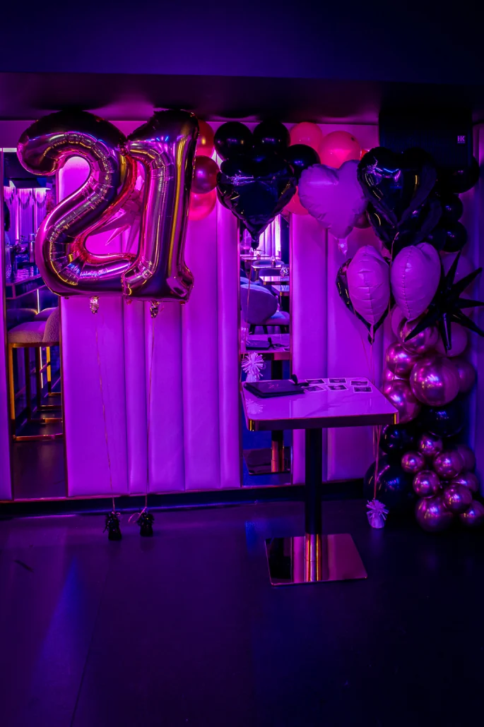 Gold 21 balloons and a balloon arch for a birthday