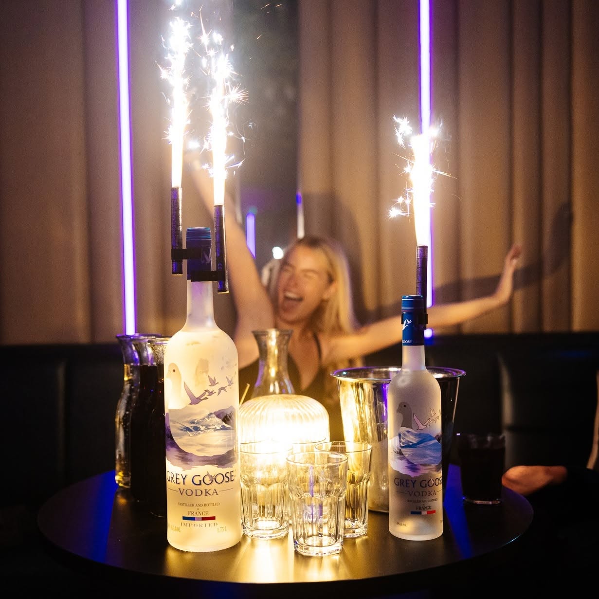 Grey Goose bottle presentation with sparklers at a VIP table